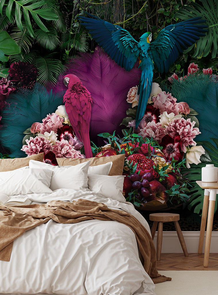 A vibrant and colorful bedroom featuring a large Parrot Paradise Wallpaper Mural from Decor2Go Wallpaper Mural with lush greenery, flowers, and vividly displayed majestic parrots including a pink parrot and a blue macaw in flight.