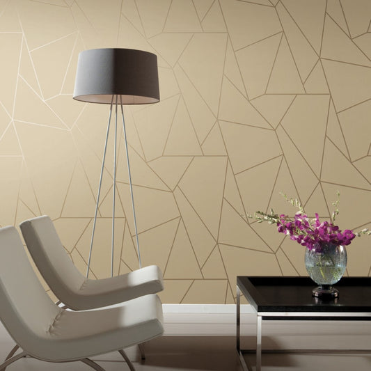 A modern living room with Pearl & Gold Nazca Wallpaper by York Wallcoverings features two white chairs and a geometric-patterned beige wall. A tall gray floor lamp complements minimalist decor, while a black coffee table with a vase of purple flowers adds color.