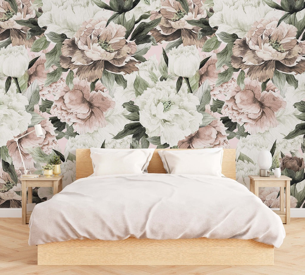 A minimalist bedroom with a wooden bed covered by a plain white duvet, flanked by two white side tables against a vibrant Decor2Go Wallpaper Mural featuring large, detailed blooms in muted Peonies and Roses.