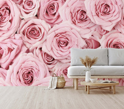 A stylish living room with a large Pink Paradise wallpaper mural from Decor2Go Wallpaper Mural, featuring a white sofa, a small wooden table with a vase of dried plants, and a woven basket.