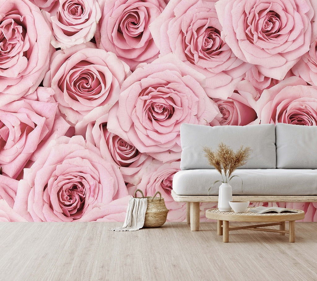 A stylish living room with a large Pink Paradise wallpaper mural from Decor2Go Wallpaper Mural, featuring a white sofa, a small wooden table with a vase of dried plants, and a woven basket.