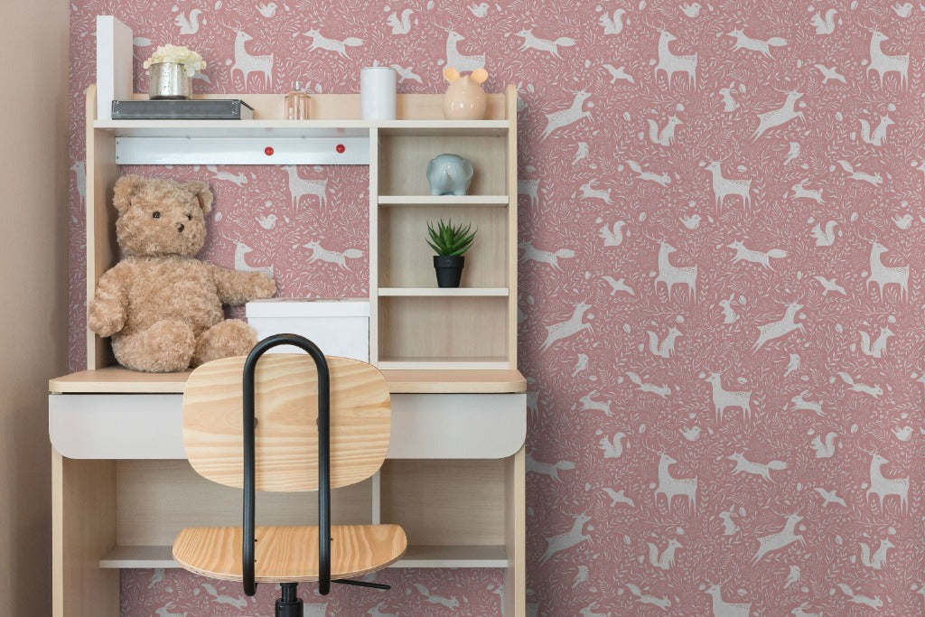Kids room with accent wall, pink animal wallpaper. The mural includes deer, squirrel, fox, and birds