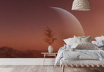 A cozy bedroom interior features a large, plush bed with grey bedding, set against a stunning Decor2Go Wallpaper Mural on the feature wall, showcasing a mountainous landscape under a starry sky.