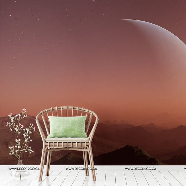 A surreal room with an open wall leading to a scenic view of mountains under a Red Planet Wallpaper Mural in the sky, featuring a wooden chair with a green cushion and a small plant beside it.