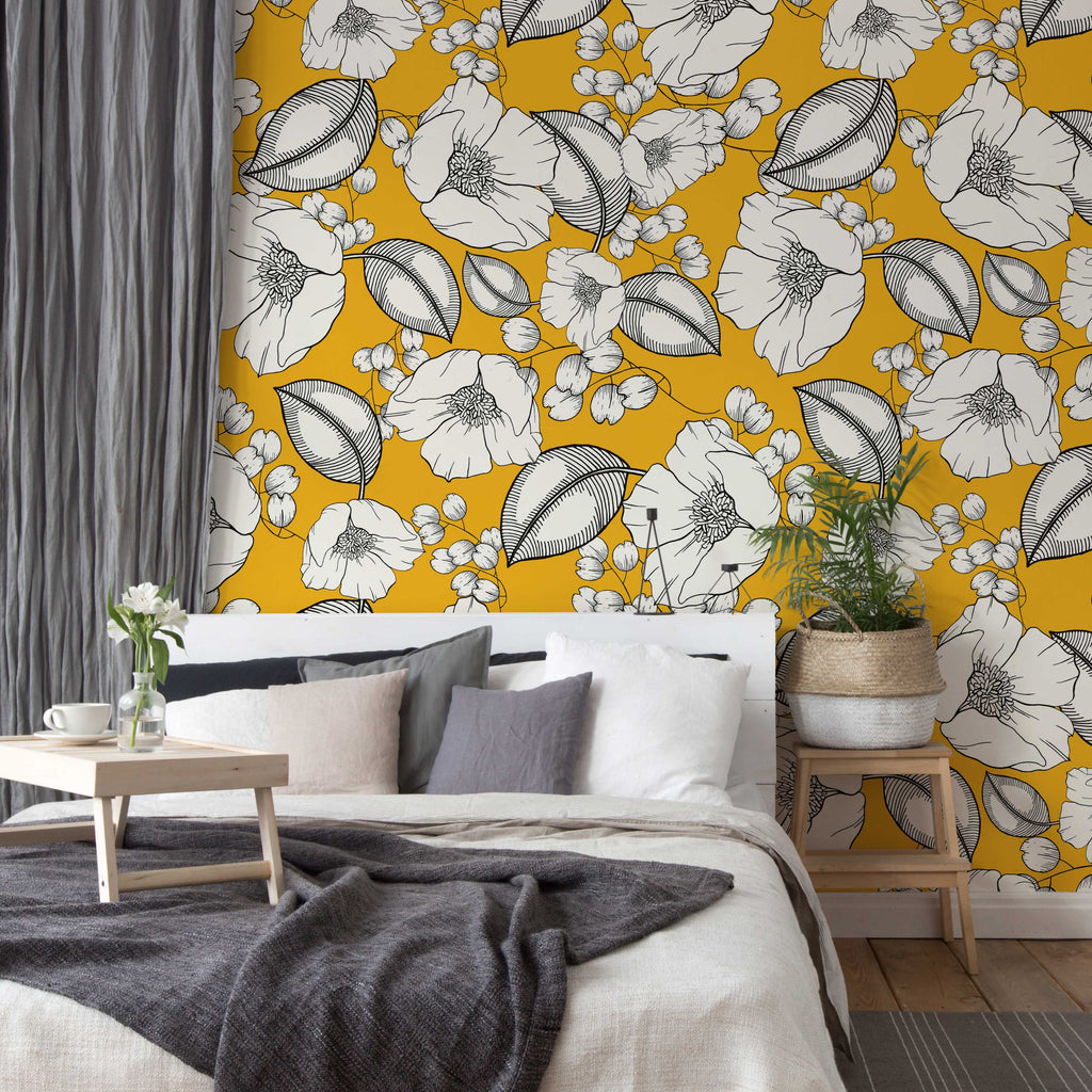 A stylish bedroom featuring a bold yellow Decor2Go Wallpaper Mural, a cozy bed with neutral bedding, a small wooden coffee table, and a potted plant in the corner. Gray curtains complement the room's decor.