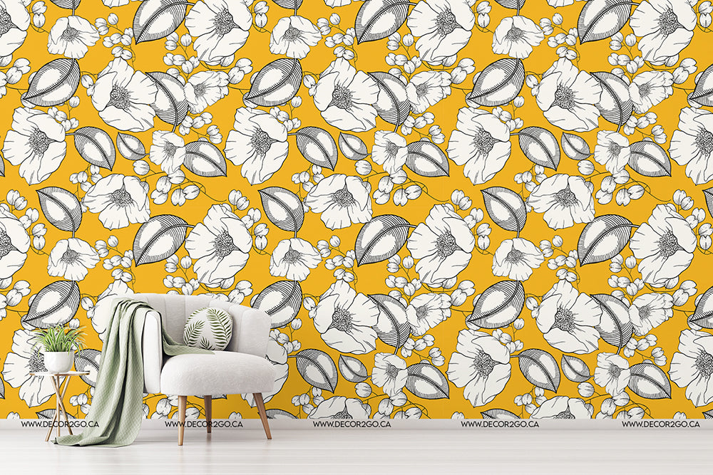 A modern living room featuring Decor2Go Wallpaper Mural with a vibrant yellow wall with a floral and leaf pattern. There's a stylish white armchair with green cushions, a side table, and a plant, creating.