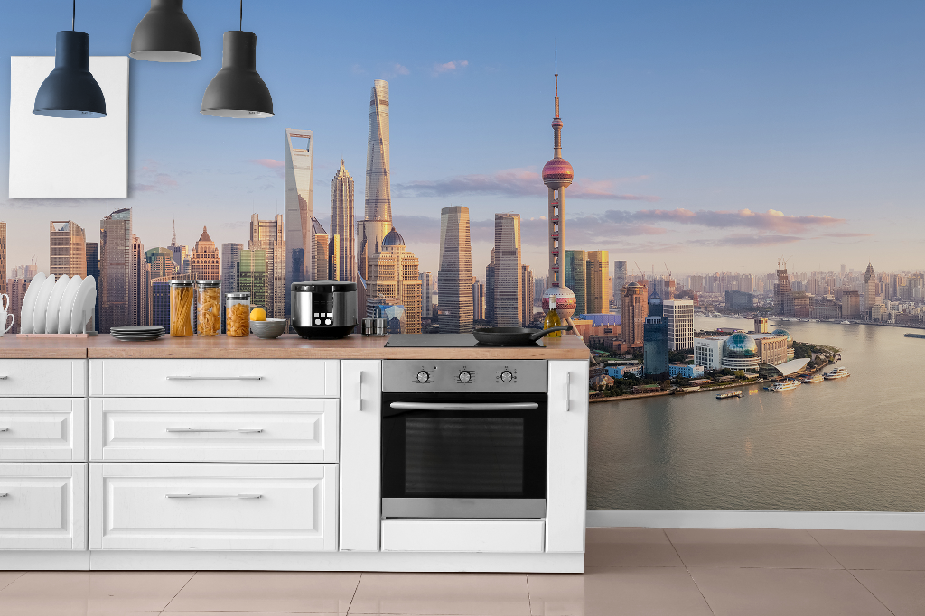A modern kitchen countertop with appliances overlooking a panoramic view of the Decor2Go Shanghai Skyline Wallpaper Mural during daytime.