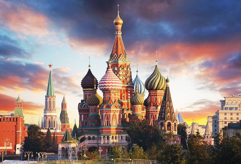Decor2Go Wallpaper Mural of St. Basil’s Cathedral in Moscow at sunset, featuring its colorful onion domes against a vivid sky with clouds.