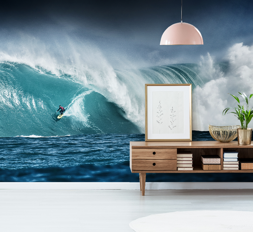 A surreal image of a surfer on a massive wave seamlessly blending into a stylishly decorated living room with modern furniture and Decor2Go Wallpaper Mural.