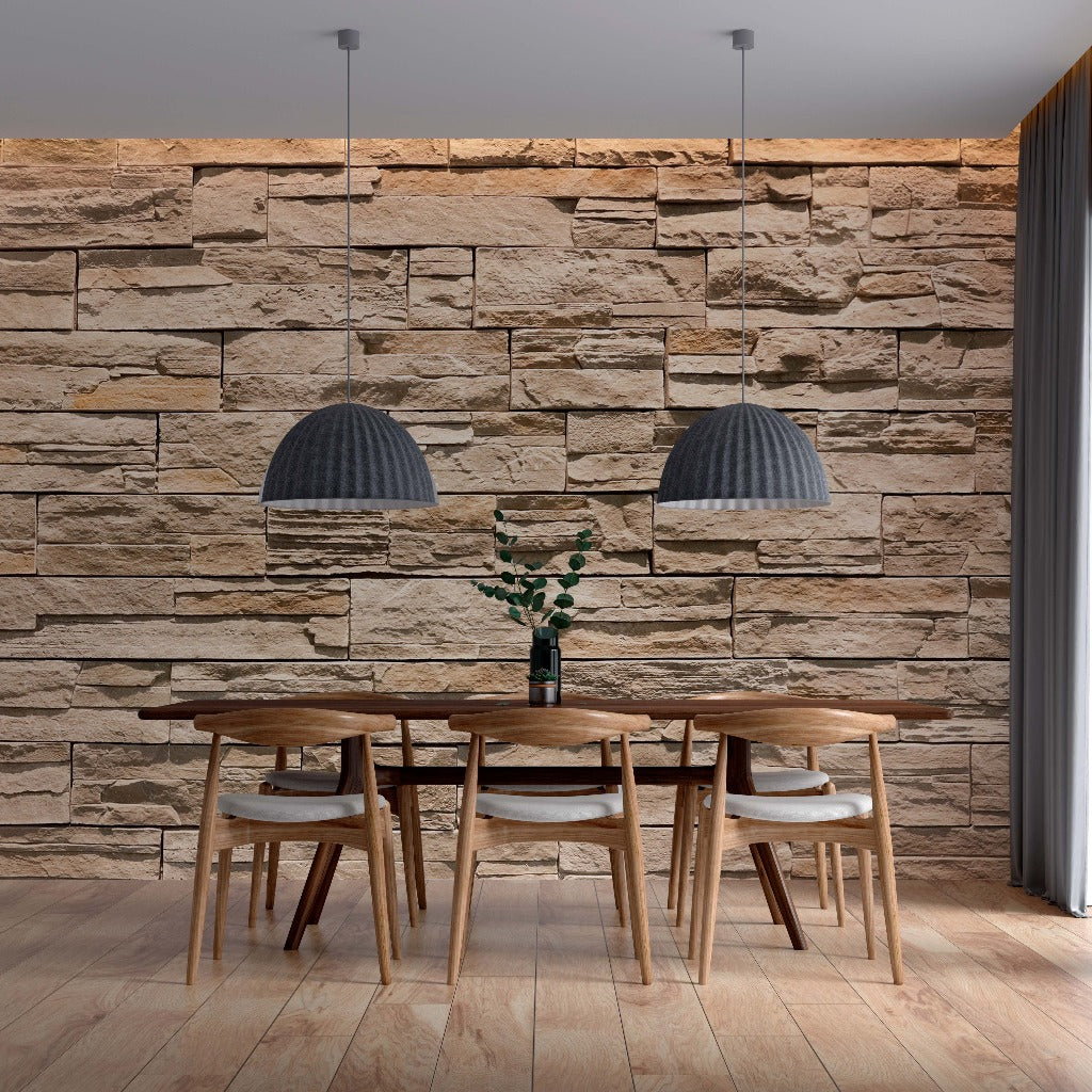 A modern dining area showcasing a wooden table, four chairs, and two hanging pendant lamps against a Decor2Go Wallpaper Mural. A vase with green branches sits on the table, under soft lighting.