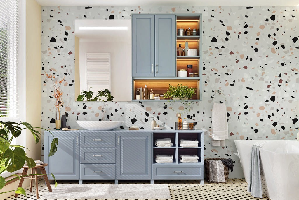 Bathroom - A stylish bathroom with luxurious Decor2Go Wallpaper Mural terrazzo design walls, featuring a blue vanity cabinet, wooden shelving, a freestanding bathtub, and a decorative plant. Bright natural light illuminates the space.