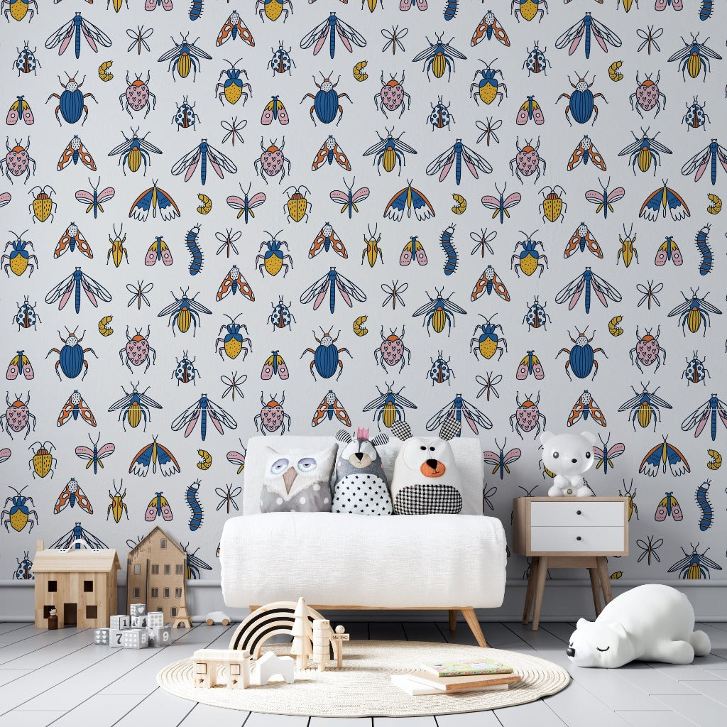 A colorful children's room featuring a feature wall with vibrant Decor2Go Wallpaper Mural, a white sofa adorned with cute animal cushions, a wooden toy house, and a sleeping toy cat on the rug.