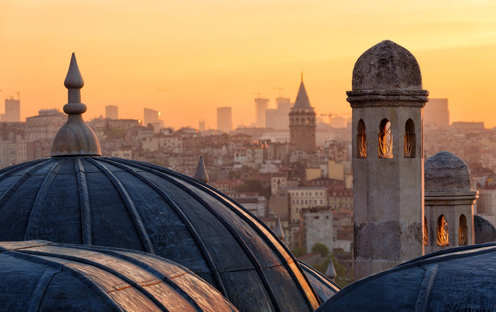 Decor2Go Wallpaper Mural of the Turkish Sunrise over Istanbul viewed from above, with the foreground showing the domes and minarets of an Ottoman-era mosque, while the modern city skyline stretches in the background.