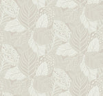 A seamless pattern of intricately detailed leaves in beige and white hues graces this Vinca Glint Wallpaper Metallic by York Wallcoverings. The leaves, varying in shape and size, are each adorned with different textures and markings on a durable non-woven material, creating a complex, elegant design.