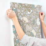 grey beige floral wallpaper hanging on the wall