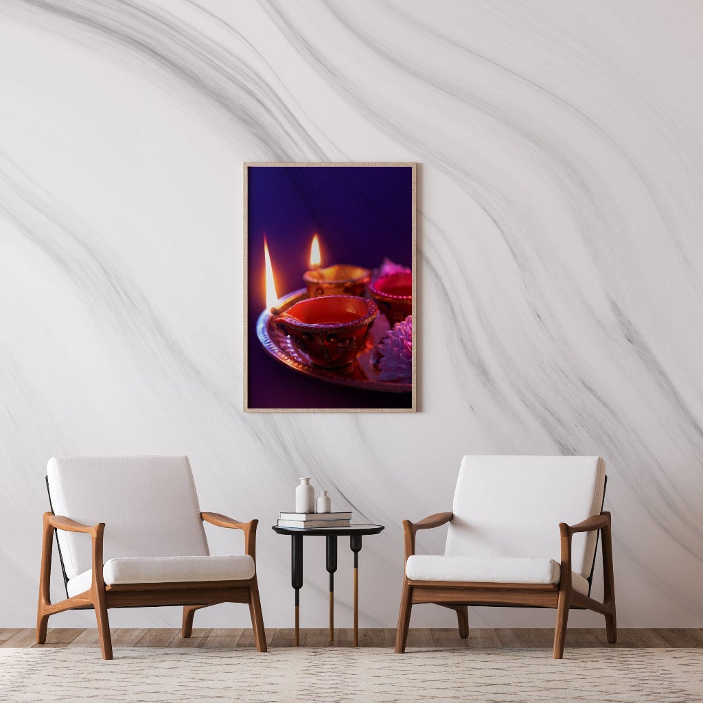 A framed photograph of lit candles in decorative holders, displayed on a Decor2Go Wallpaper Mural wall above a small table between two wooden armchairs with white cushions.