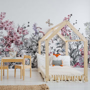 Kids room - A cozy children's bedroom with a wooden house-shaped bed frame, colorful pillows, and a small wooden table with chairs. The room is decorated with Decor2Go Wallpaper Mural featuring Wild Flower designs.