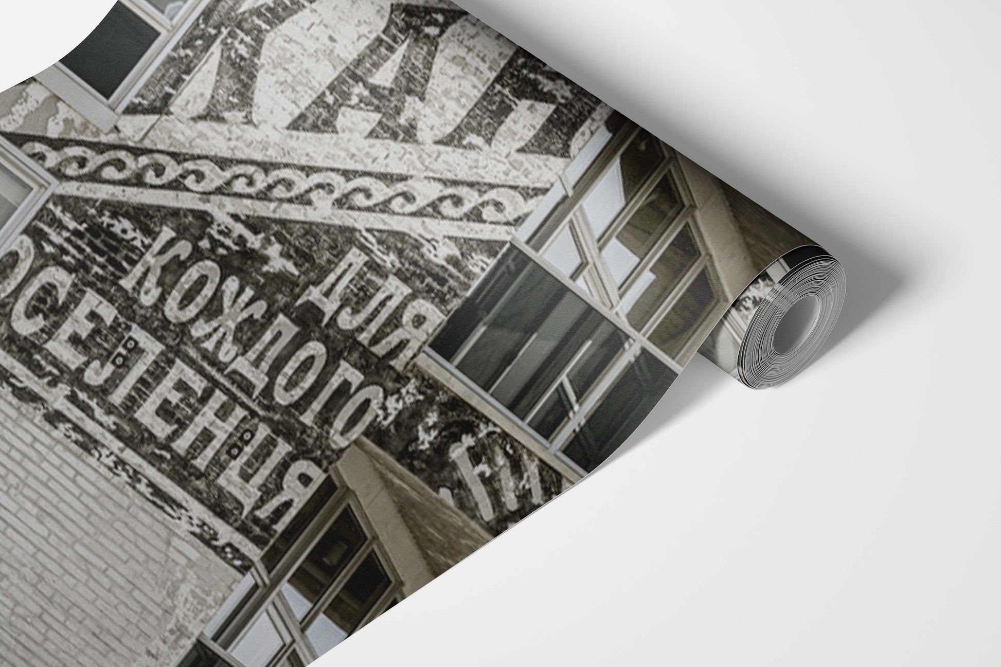 Roll of wallpaper with architectural design and text in a sepia tone.