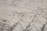 A close-up image of a faded, vintage world map featuring intricate lines and detailed markings. The map appears to be drawn in monochrome and has a worn, textured surface, evoking an antique look. With contours and boundaries faintly visible, the scene pattern resembles Palitra Voyage Wallpaper (114 SqFt).