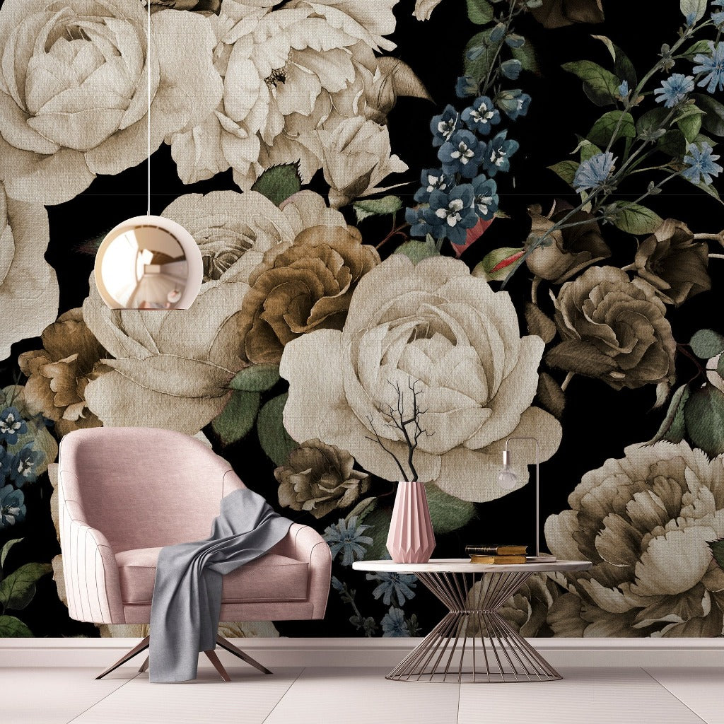 A stylish interior with a large Decor2Go Wallpaper Mural featuring peonies and blue flowers in a monochrome palette, including a pink armchair, a small circular table with books and a vase, and an elegant