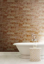 The image shows a modern bathroom with a vintage style. It features a white freestanding bathtub with a silver faucet and a decorative white basket nearby. The wall behind the tub is adorned with York Wallcoverings Urban Chic Up The Wall Wallpaper (56 SqFt), adding an element of architectural décor to the space.