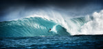 A surfer rides a massive, cresting blue wave under a stormy sky, showcasing the dramatic and powerful ocean in this Decor2Go Wallpaper Mural.