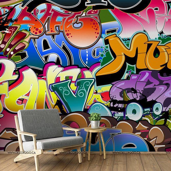 Modern living room with a minimalist gray chair and wooden side table against a vibrant, colorful Decor2Go Wallpaper Mural featuring various abstract designs and shapes.
