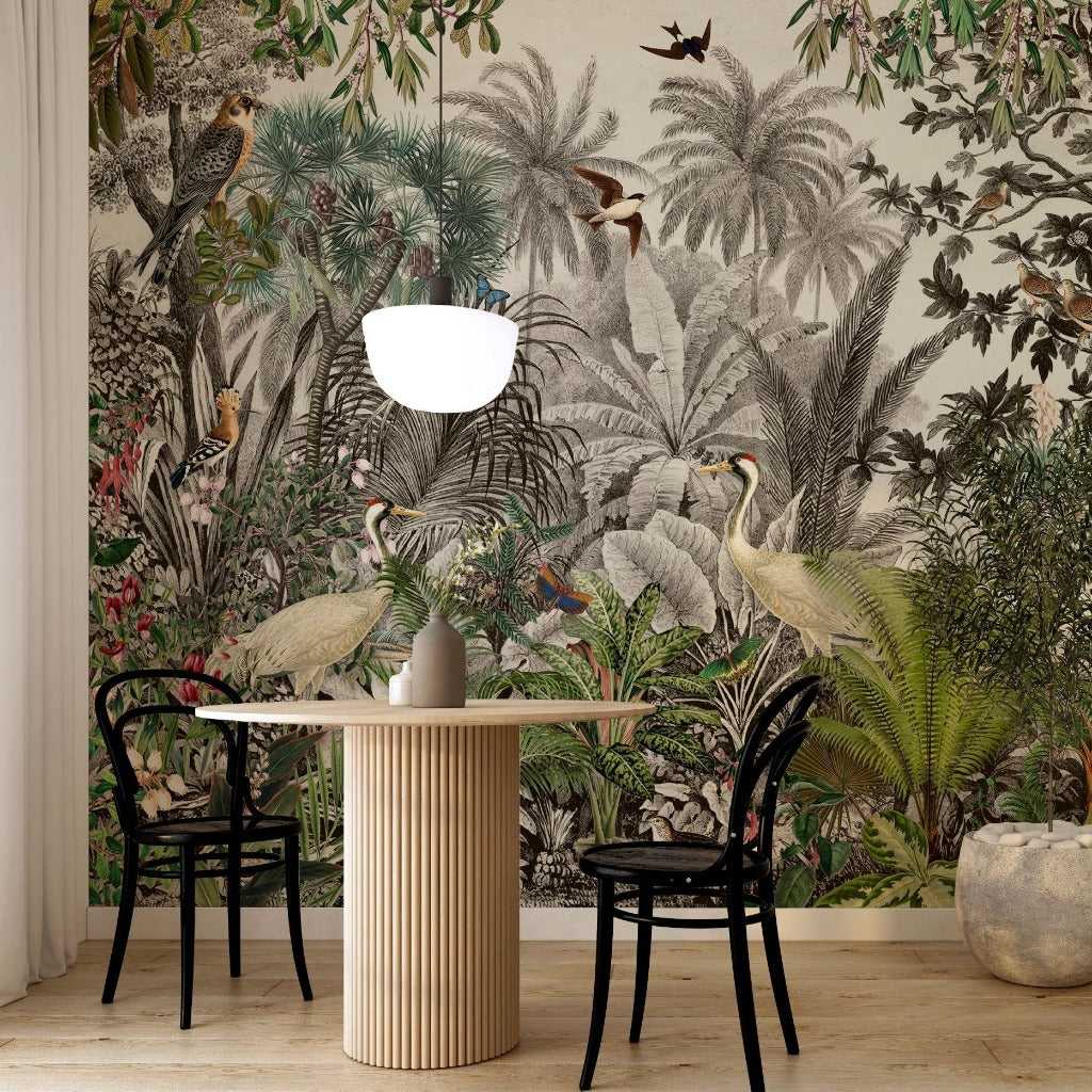 A dining area with a small round table and two black chairs against a detailed Vintage Jungle Wallpaper Mural from Decor2Go Wallpaper Mural, exuding a vintage style. A stylish lamp sits on the table, and a vase is near.