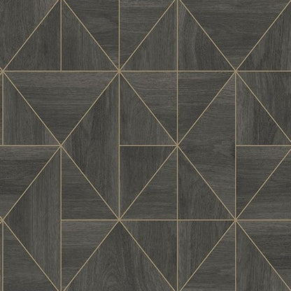 A geometric print featuring intersecting lines forming triangles and rectangles is displayed on a dark gray, textured surface. The design is highlighted with thin, gold lines that divide the shapes, creating a contemporary and sophisticated appearance, perfect for York Wallcoverings Cheverny Geometric Wood and Gold Wallpaper (56 SqFt).